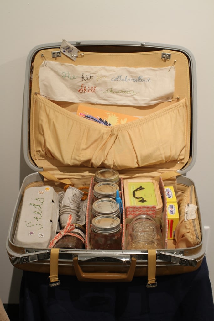 Vintage suitcase containiing canning supplies