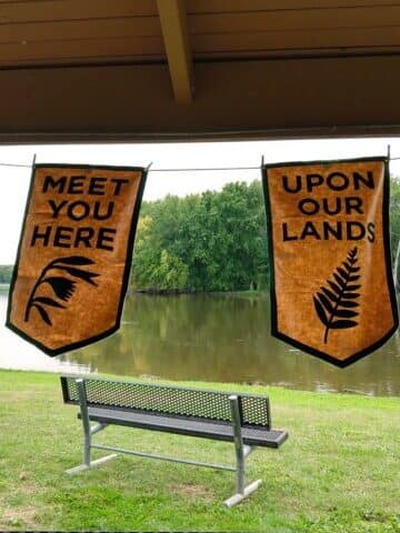 Banners from Dylan Miner’s project “The Land is Always” installed on the banks of the Mississippi River at the opening event programming for Anthropocene Drift, September 25, 2019. by Katie Netti/Meredith Dallas