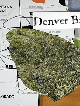 Film still featuring a collage of a map of the Great Plains and the Denver Basin geological formation being peeled back to reveal grass