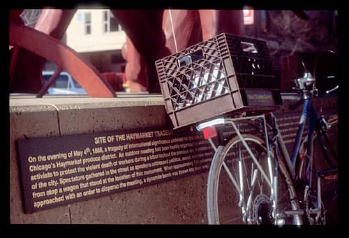 Radio transmitting bicycle leans against the Haymarket Monument in Chicago.